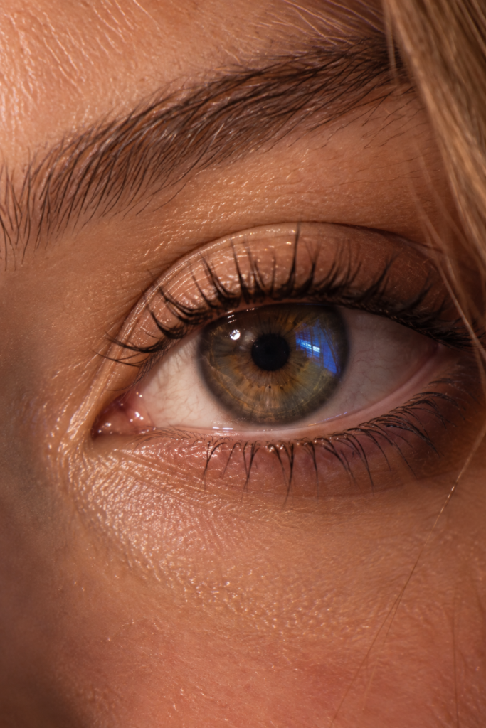 Extreme close-up of a human eye with a faint glowing digital reflection in the pupil, trust looks real up close, and that's exactly the part AI hasn't fully cracked
